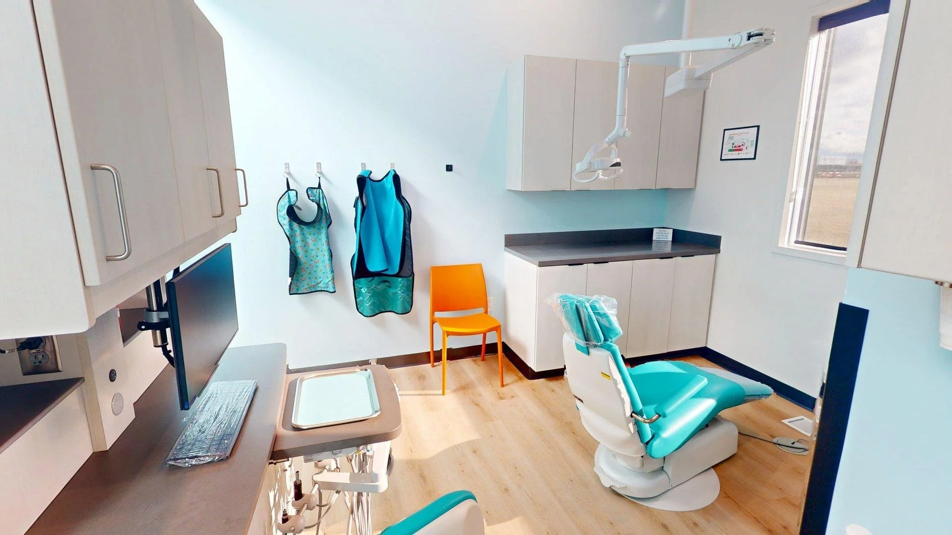 Kid friendly pediatric dentistry treatment room at All About Kids Pediatric Dentistry in Napoleon Ohio with a colorful dental chair and calming design.