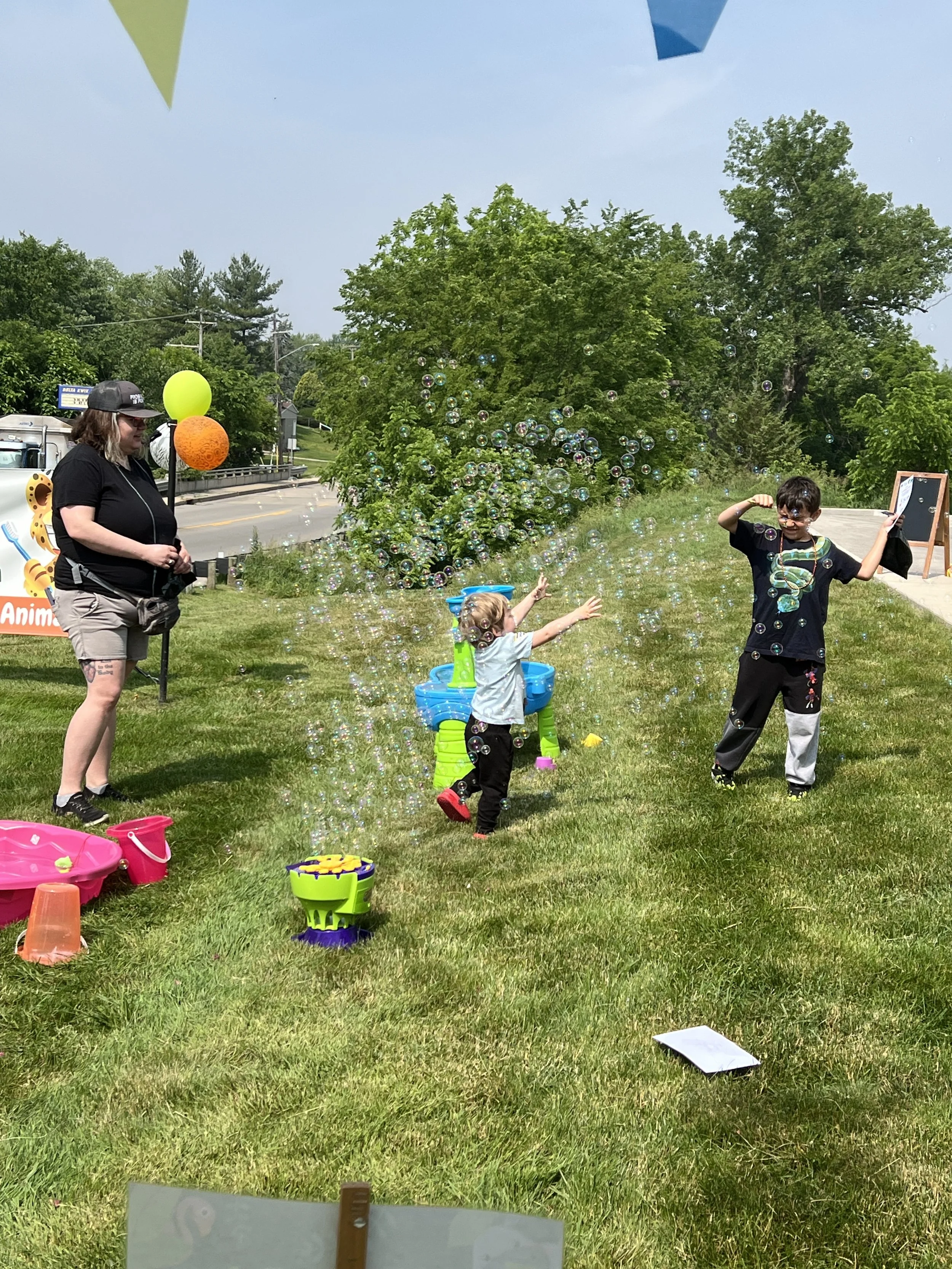 Children playing with bubbles and enjoying outdoor activities at All About Kids Pediatric Dentistry Kids’ Day event in Napoleon Ohio.