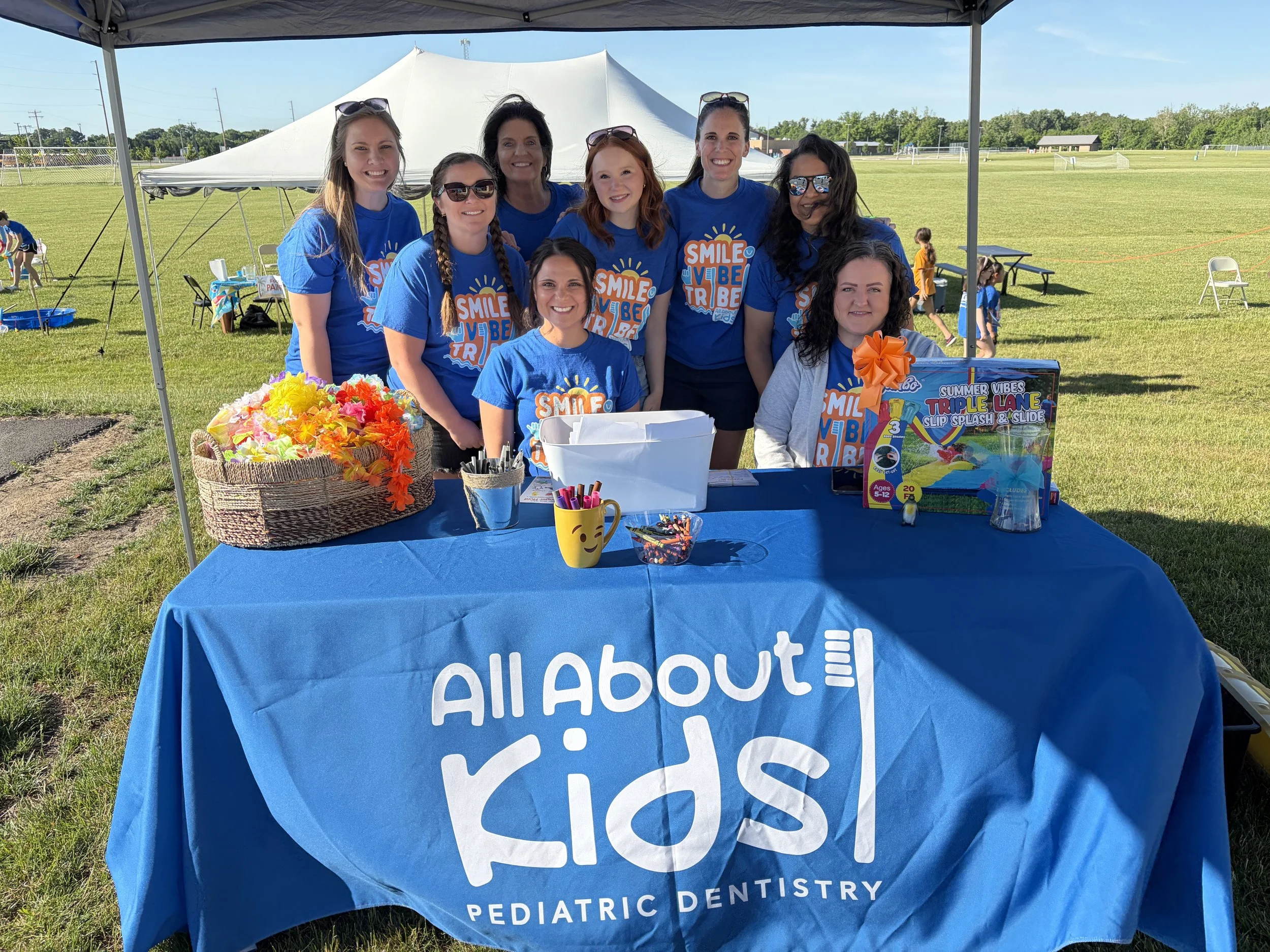 The All About Kids Pediatric Dentistry team welcoming families at the annual Family Fun Day community event.