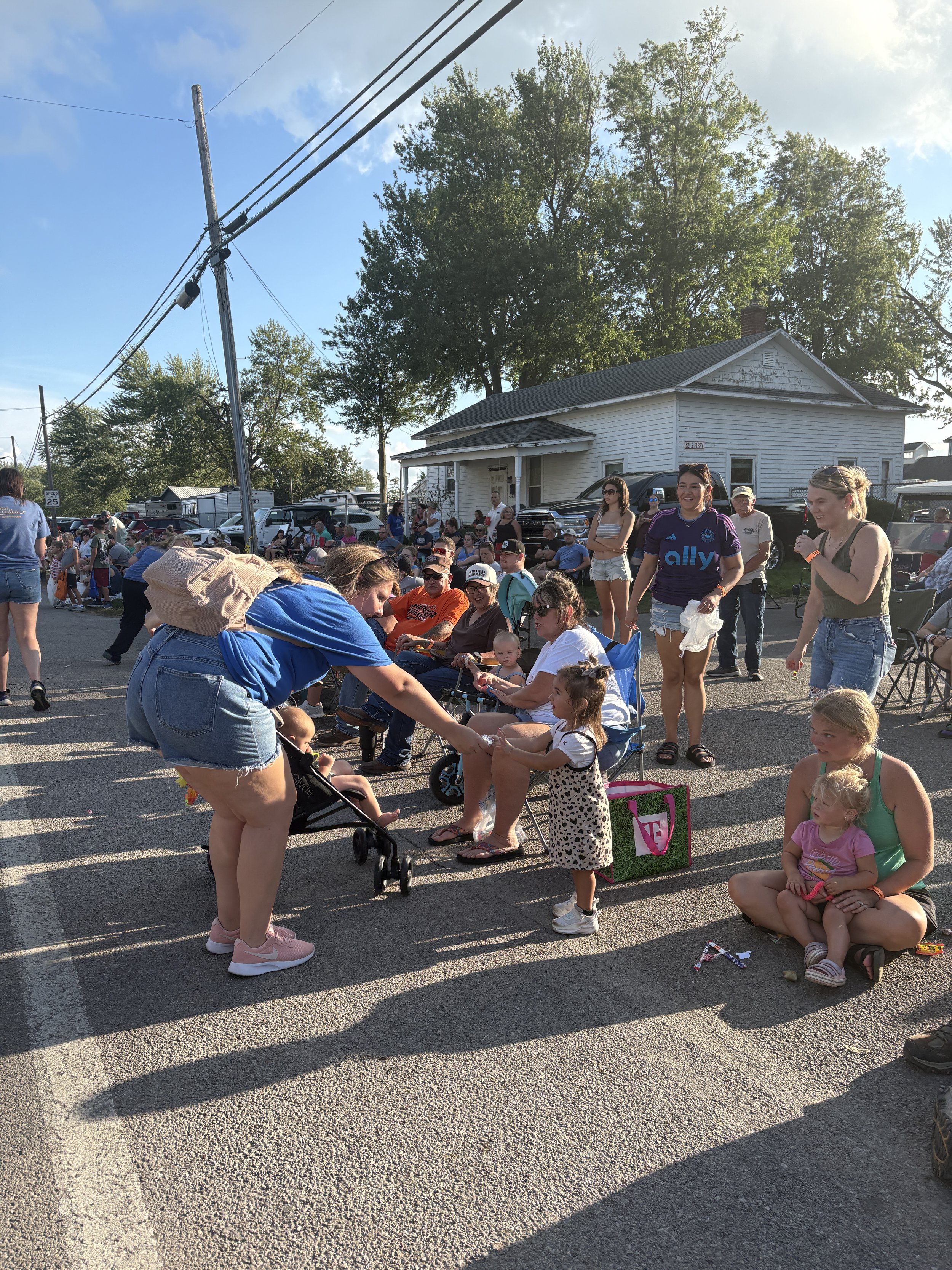 All About Kids Pediatric Dentistry team member handing out treats to children watching the Henry County Parade in Napoleon, Ohio.