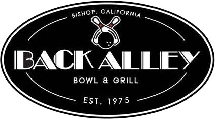 A black oval logo for Back Alley Bowl & Grill, located in Bishop, California, established in 1975, featuring a small graphic of a bowling pin and ball.