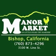 Sign for Manor Market in Bishop, California, with a mountain and rooster logo, green background, and contact information including phone number and address.
