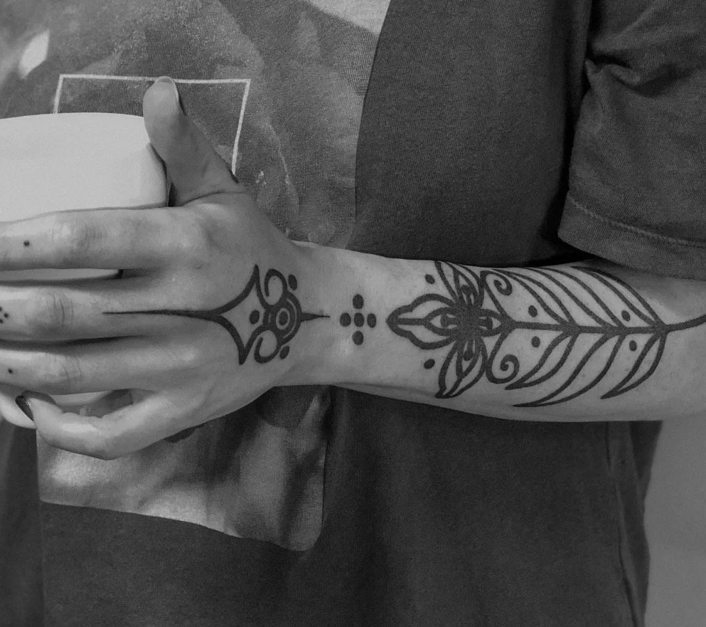 Connected ornament across the hand and forearm.