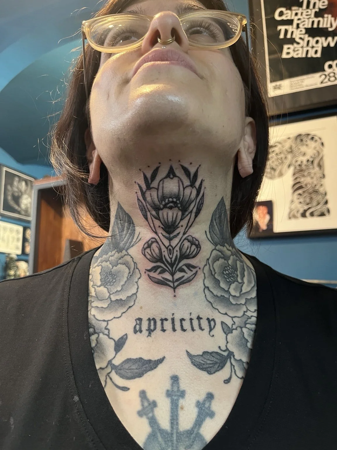 Floral ornamental tattoo on the neck.