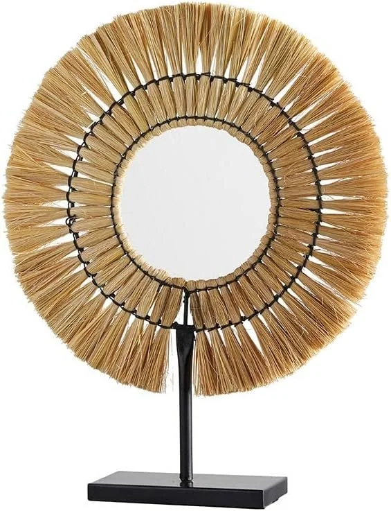 Decorative mirror with a circular frame made of natural straw or fibers, mounted on a black stand with a rectangular base.
