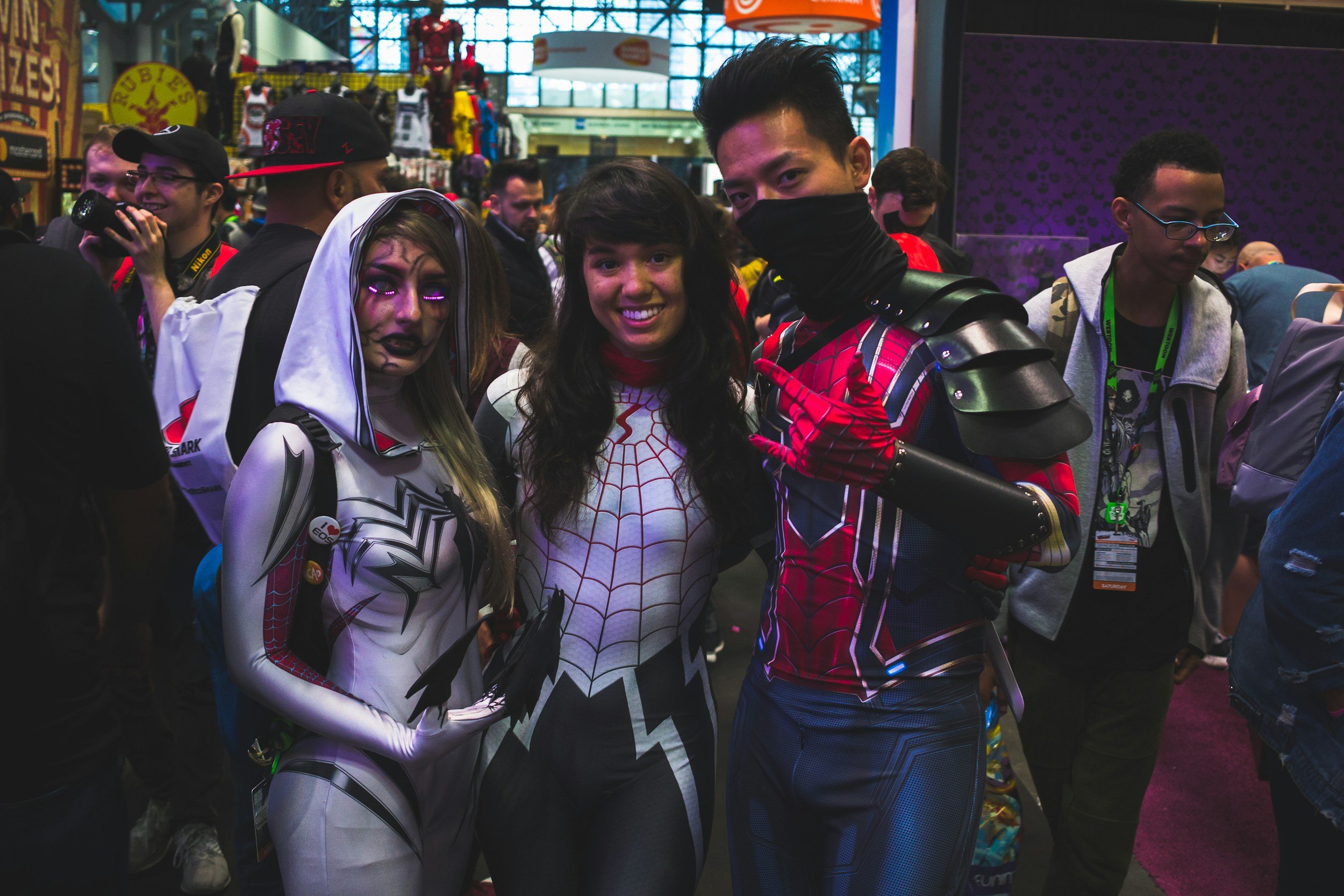 cosplayers posing for a photo at a comic convention