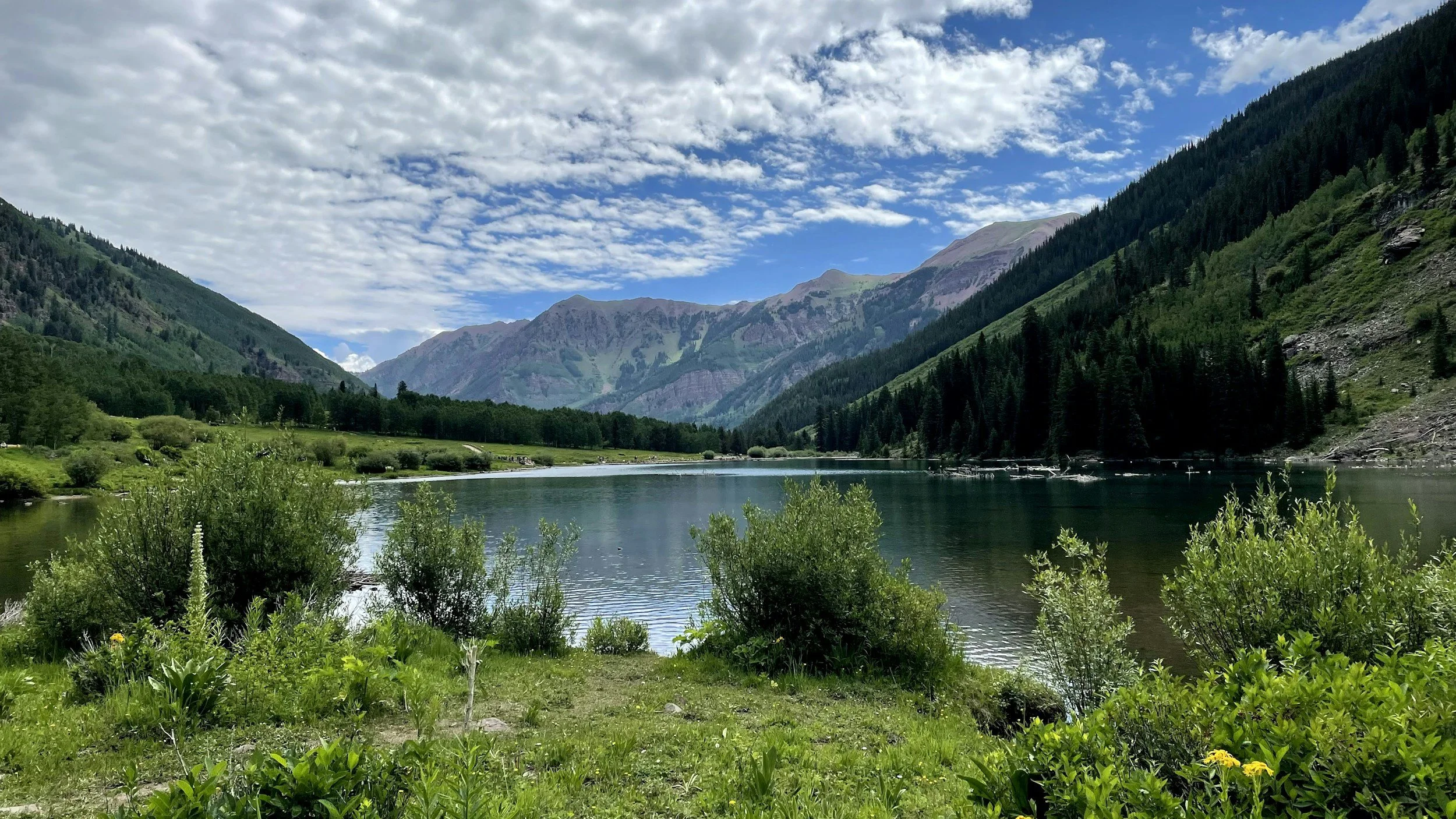 a gorgeous scenic landscape view of a lake with mountains in the distance