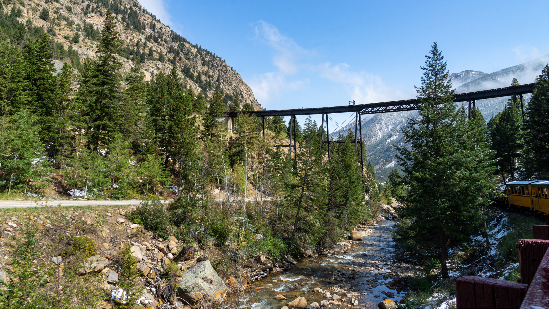 The Georgetown Loop Railroad train passes under an overhead trestle