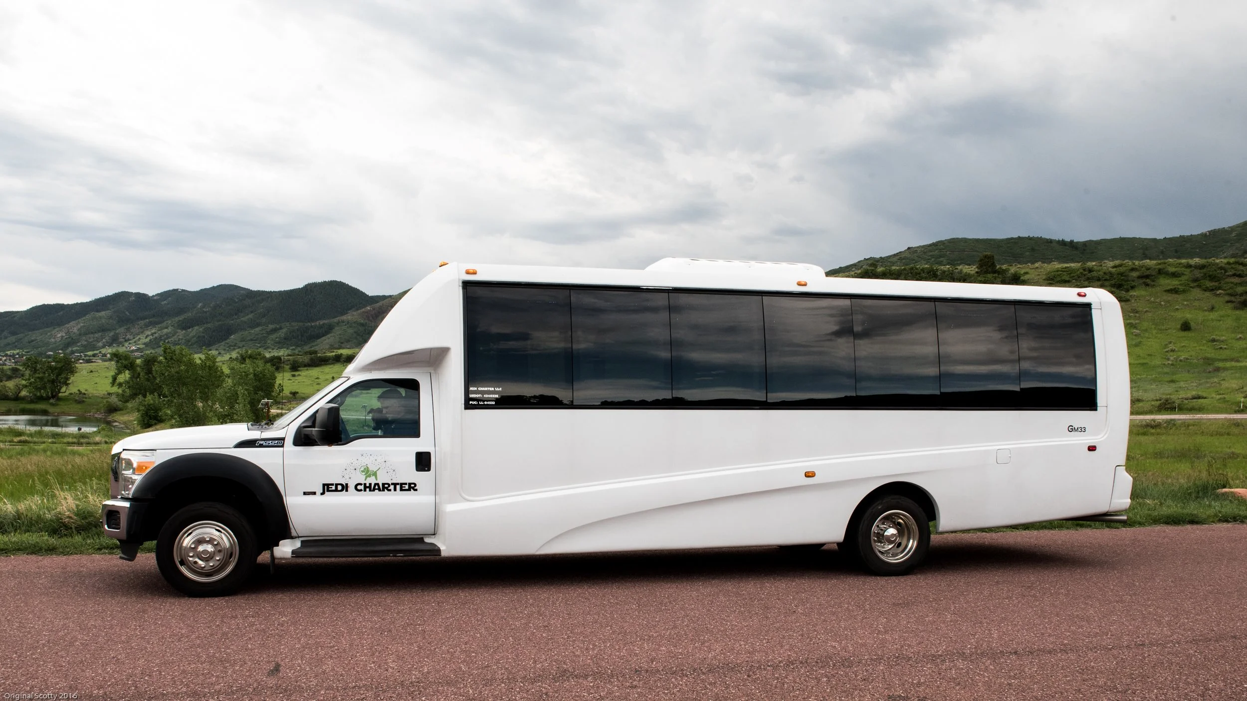 Exterior of Jedi Charter bus with Colorado mountains in the background