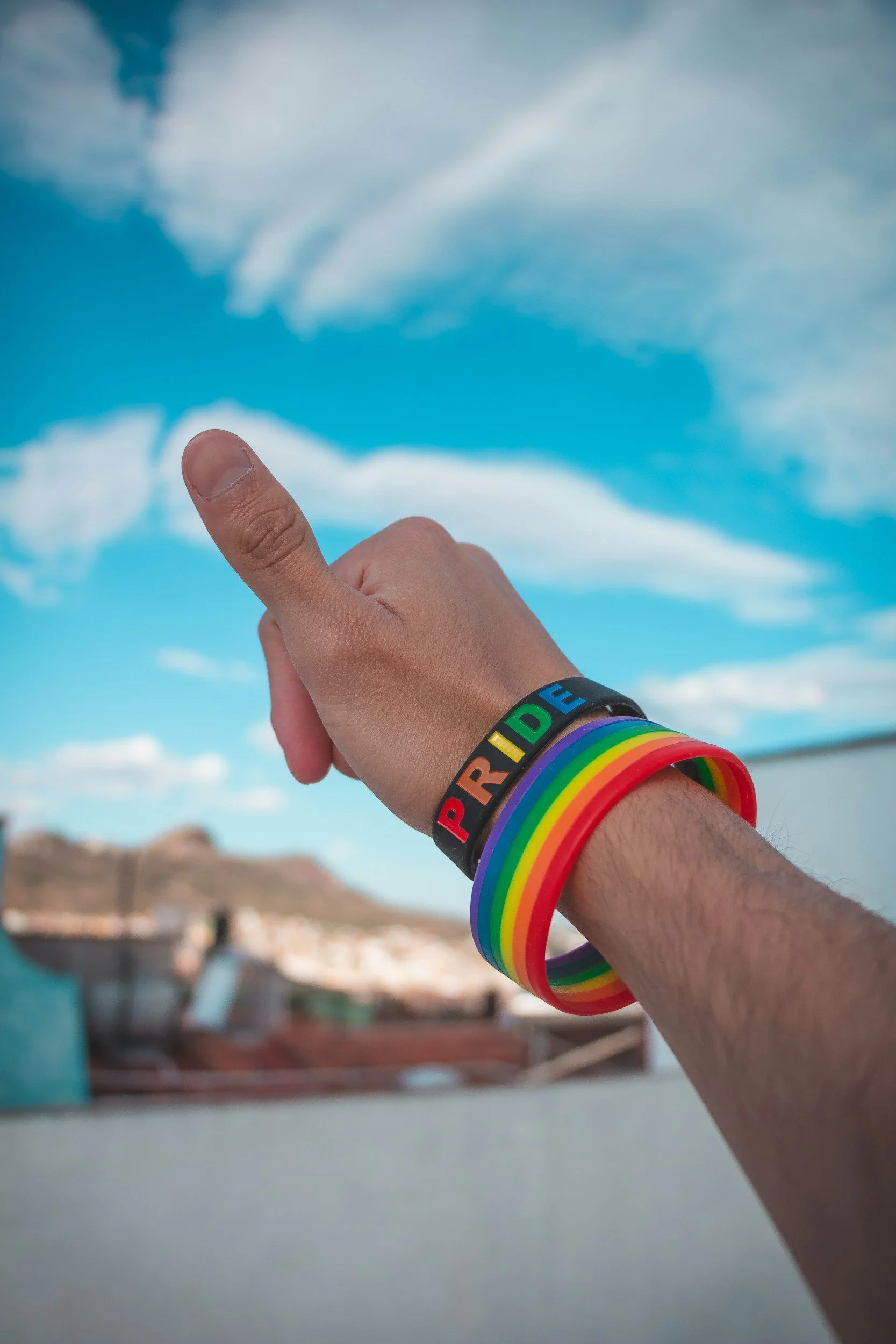 Person wearing a rainbow pride bracelet representing LGBTQ+ identity – affirming and inclusive LGBTQ+ therapy at CogDiversified.