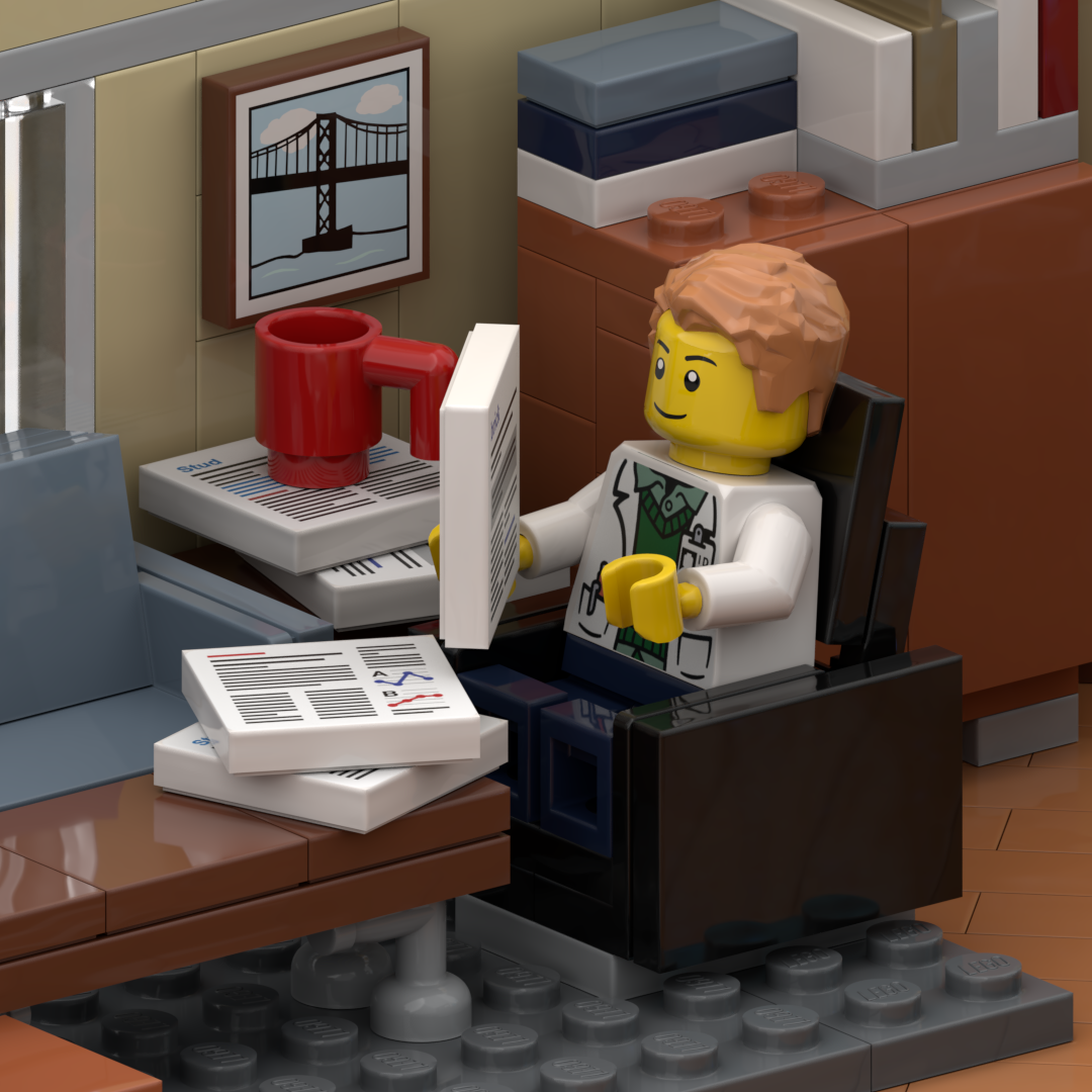 LEGO scene of a LEGO doctor working at a desk with a computer, papers, and a red coffee mug, in an office setting with shelves, a framed picture of a bridge on the wall, and LEGO furniture.
