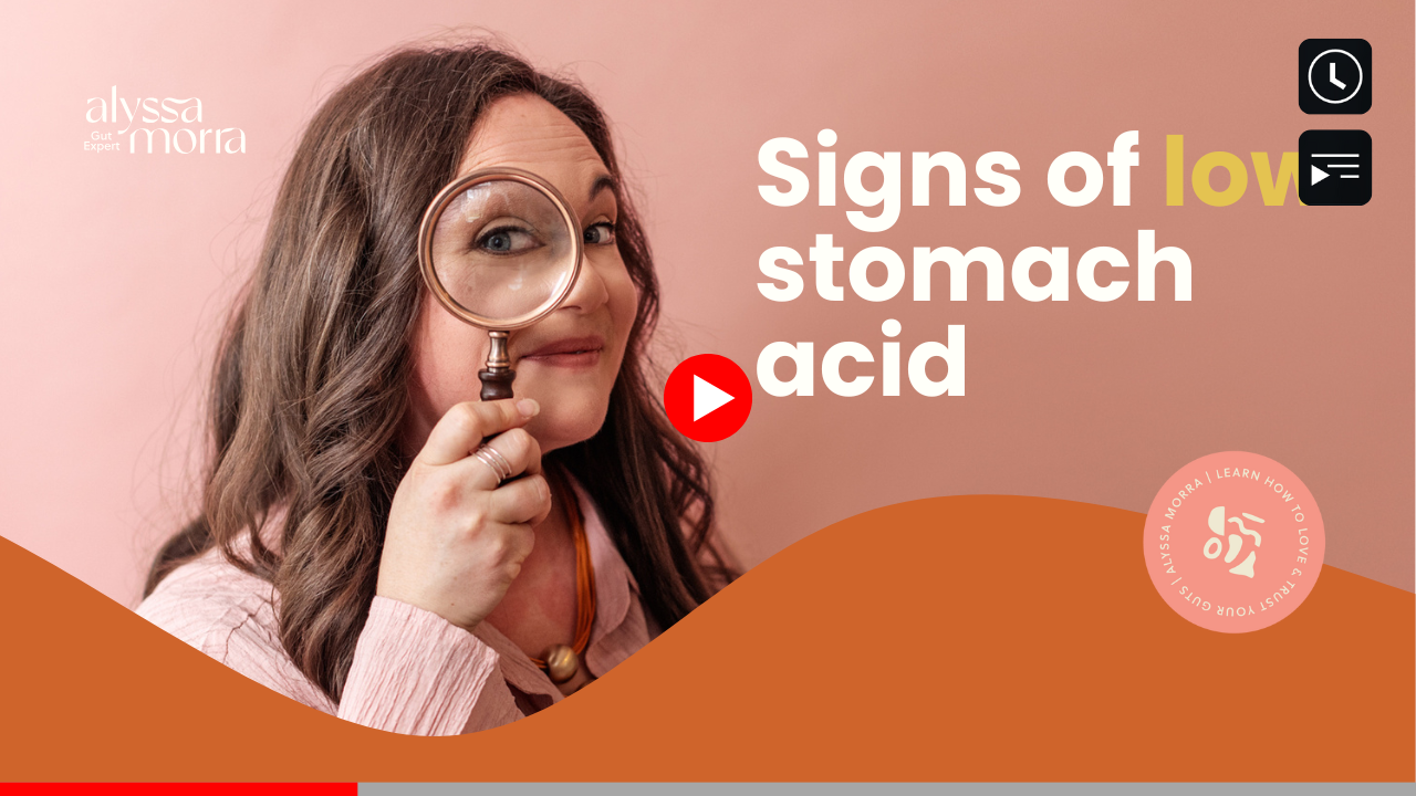 Thumbnail for a YouTube video titled "Signs of low stomach acid" featuring a smiling woman with long hair, wearing a pink shirt, looking through a magnifying glass. The text also reads "Alyssa Morra Gut Expert. Learn how to love & trust your guts"