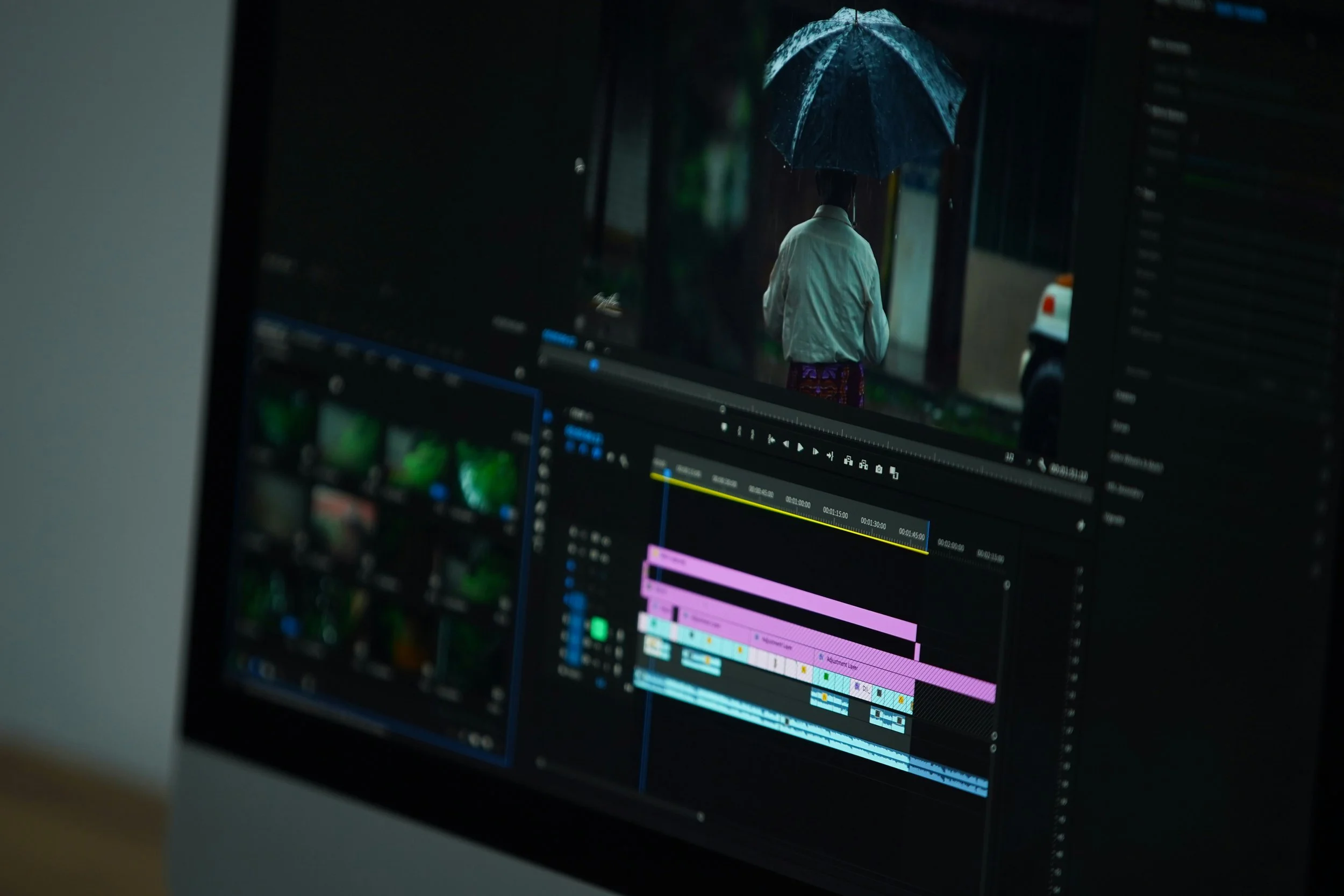 Computer screen showing a video editing software with a scene of a person holding an umbrella.