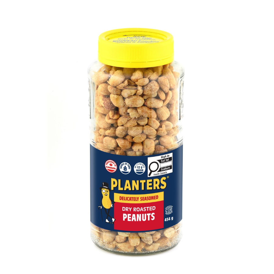 A clear jar of Planters dry roasted peanuts with a yellow lid, featuring a blue and red label with a cartoon peanut wearing a hat and glasses.