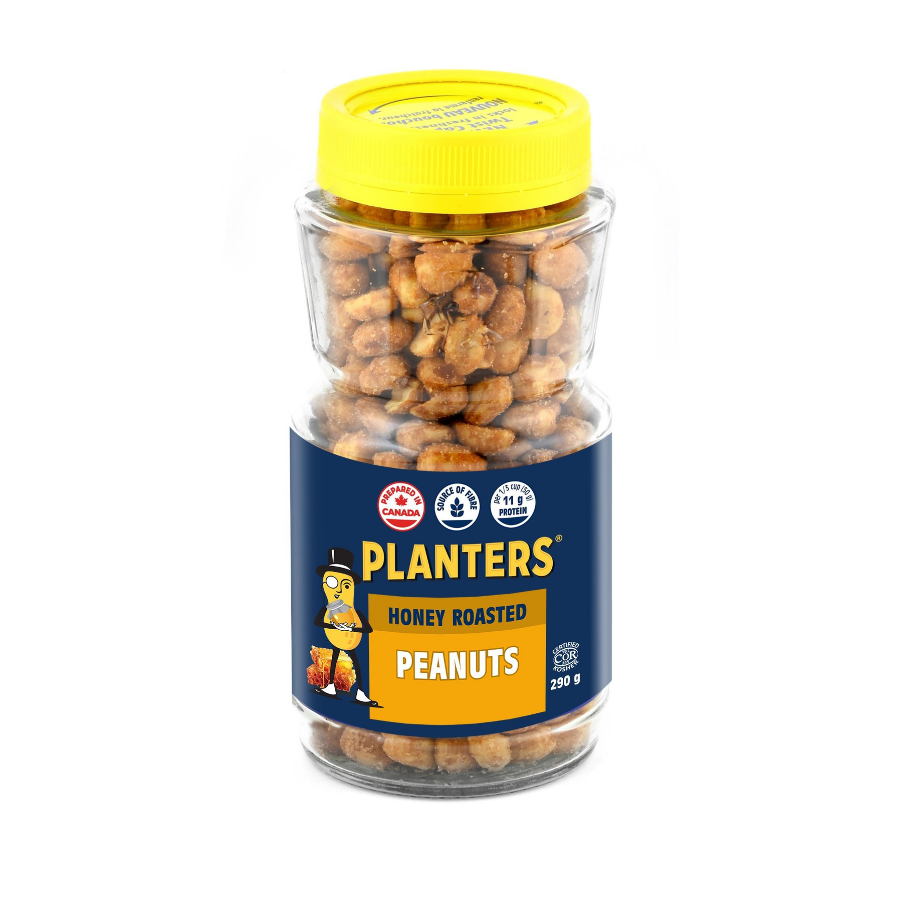 A transparent jar of honey roasted peanuts with a yellow lid and a blue label that reads "Planters Honey Roasted Peanuts." The label features a cartoon character and icons indicating source of fiber and protein content.