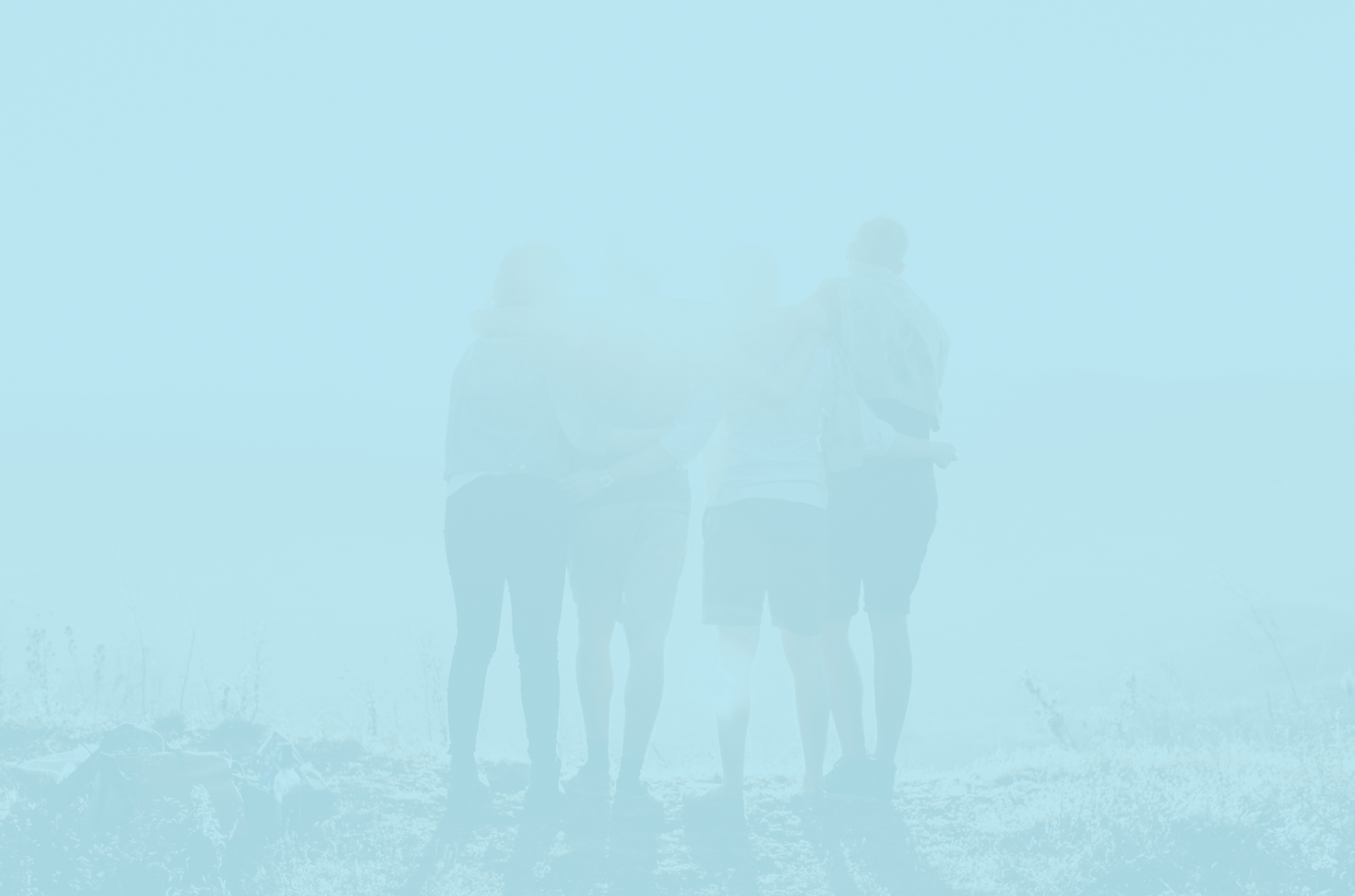 Silhouettes of four people standing together outdoors facing away, with light shining on them and a blurred background.