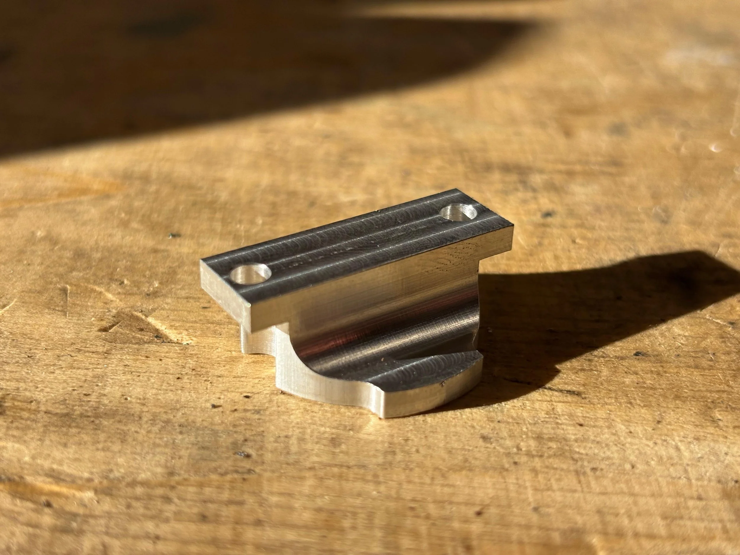 A custom‑machined aluminium bike‑light bracket produced to replace a broken plastic original. Designed for increased strength and long‑term durability, the new bracket was manufactured using a combination of manual milling, turning and CNC machining 