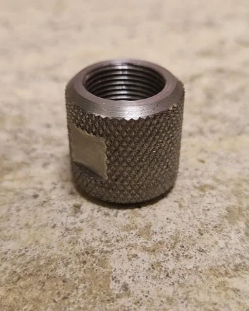 A precision‑machined steel connector featuring a deep knurled grip, accurately milled flats and a cleanly cut threaded section, designed for joining and securing fire staff components. Manufactured using manual turning, milling and threading operatio