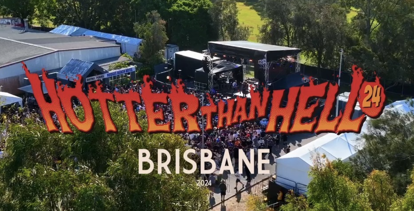 An outdoor music festival with a stage, crowd, and food tents in Brisbane, Australia, during daytime, with colorful festival text overlay.