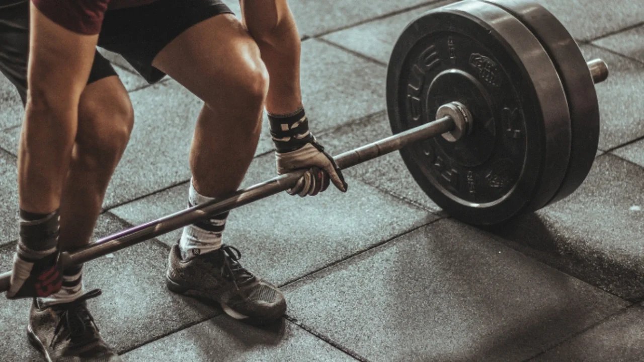 Strength training exercise focused on spinal support and back pain relief at Newport Fitness in Newport Beach