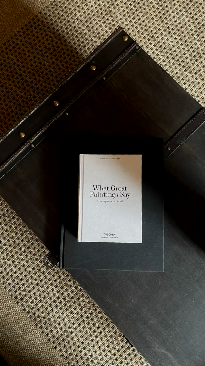 A book titled 'What Great Paintings Say' resting on a table in The Dun Cow lounge area.