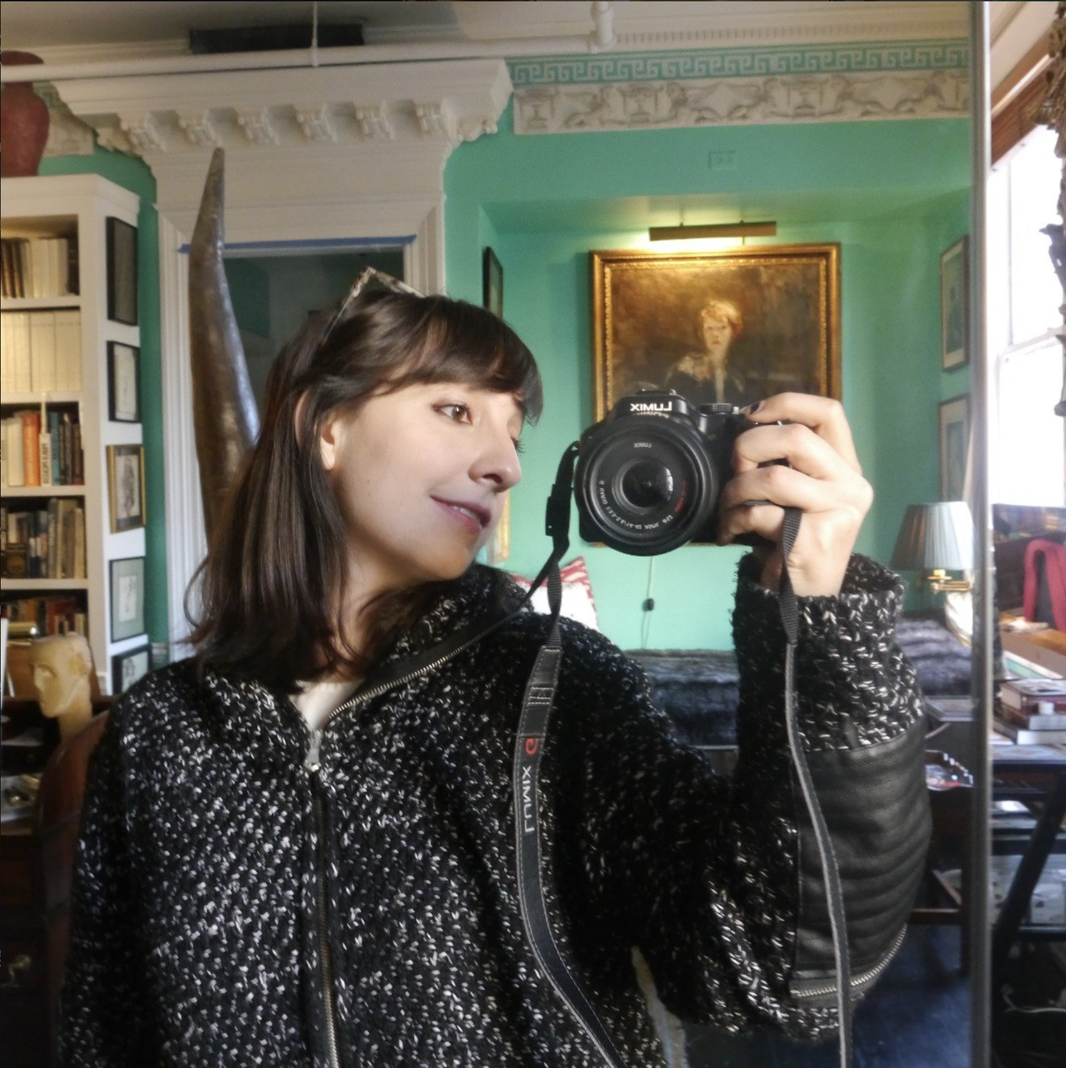 Dominique takes a selfie in a maximalist interior
