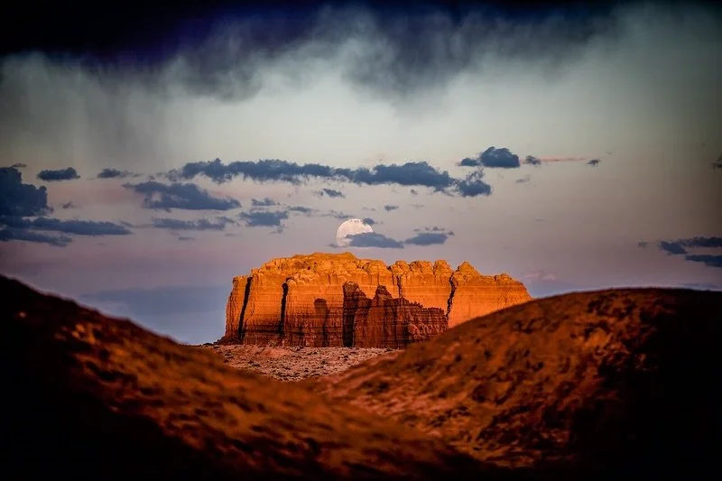 Moonrise Over Goblin Valley.
.
Happy Halloween! 

After dinner at our Goblin Valley campsite, I noticed the last light of the setting sun hitting the rock formations to the east. At the same time, a huge moon began to rise above them, casting a soft 
