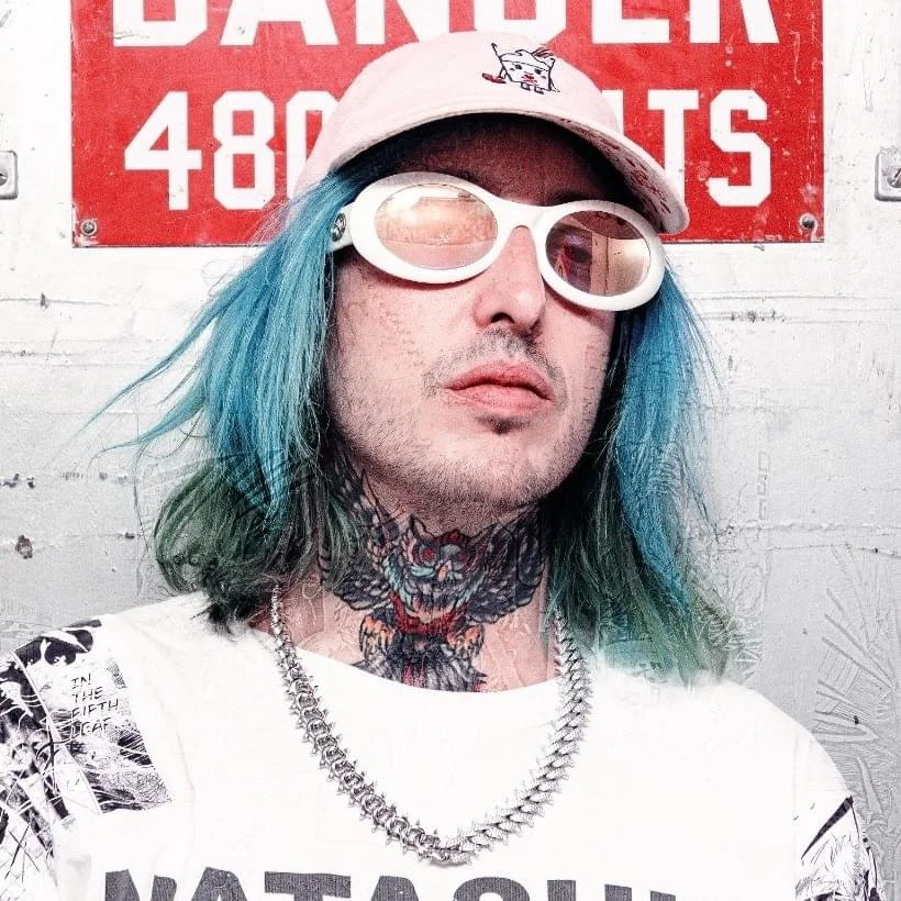 A punk rock musician stands confidently in a gritty urban setting, wearing dark clothing and a defiant expression, embodying rebellion, political edge, and underground music culture.