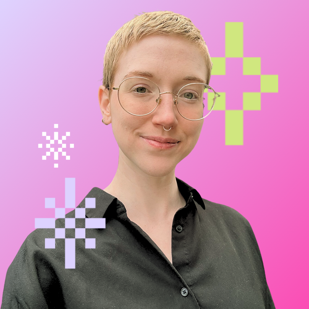Young woman with glasses and short hair standing with arms crossed against a pink background with pixelated flower designs.
