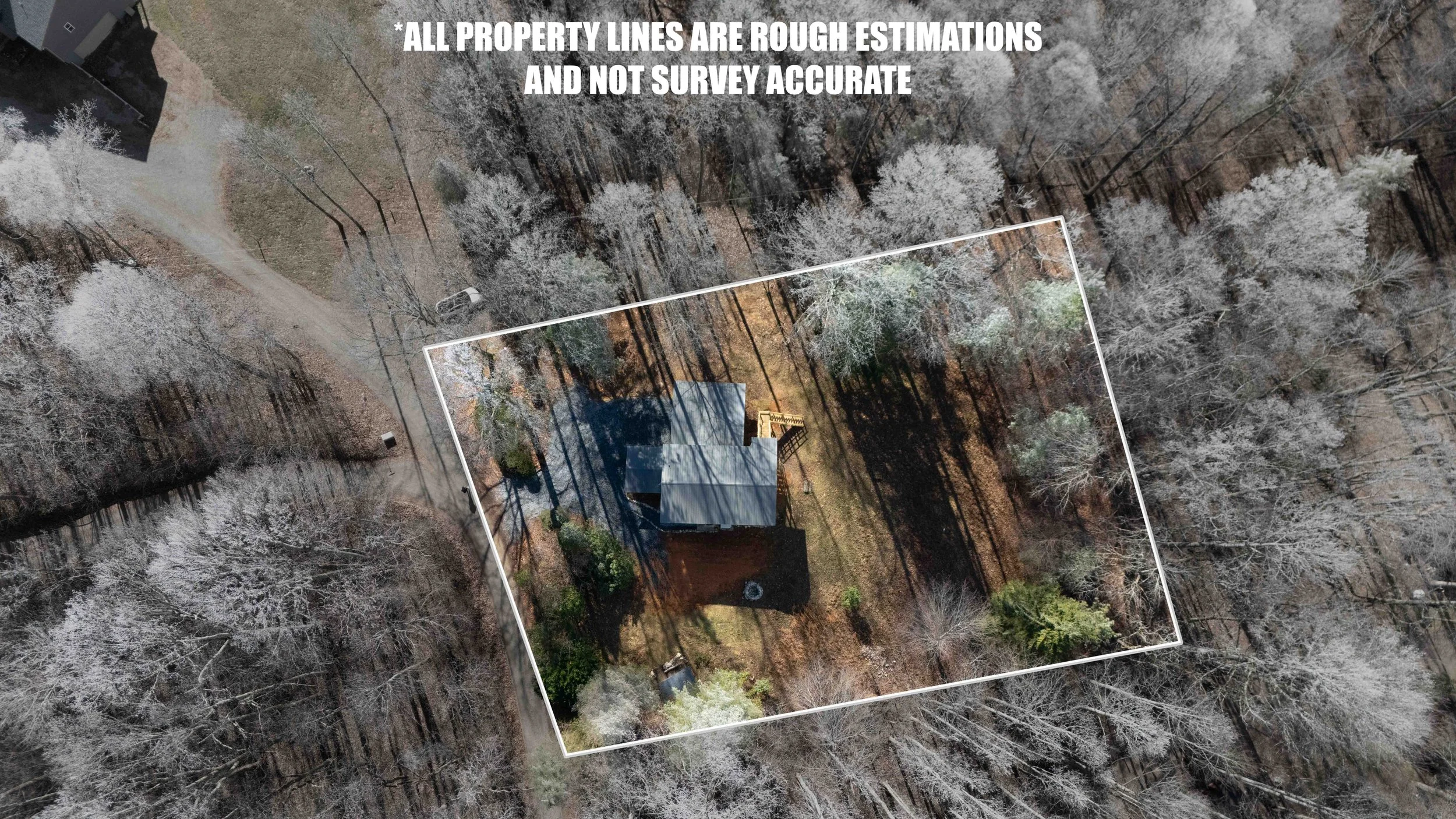 Aerial view of a house within property lines marked by white lines, surrounded by trees and a dirt driveway, with text indicating that property lines are rough estimates and not survey accurate.