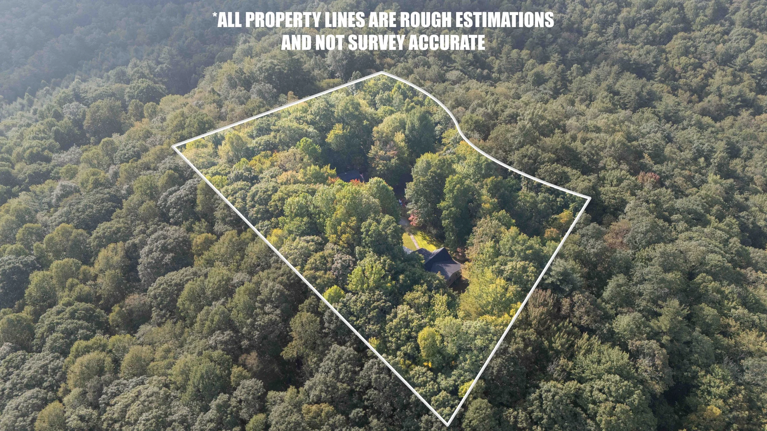 Aerial view of a large wooded property with a house and driveway, outlined with a white property line and a note indicating property lines are rough estimates and not survey accurate.