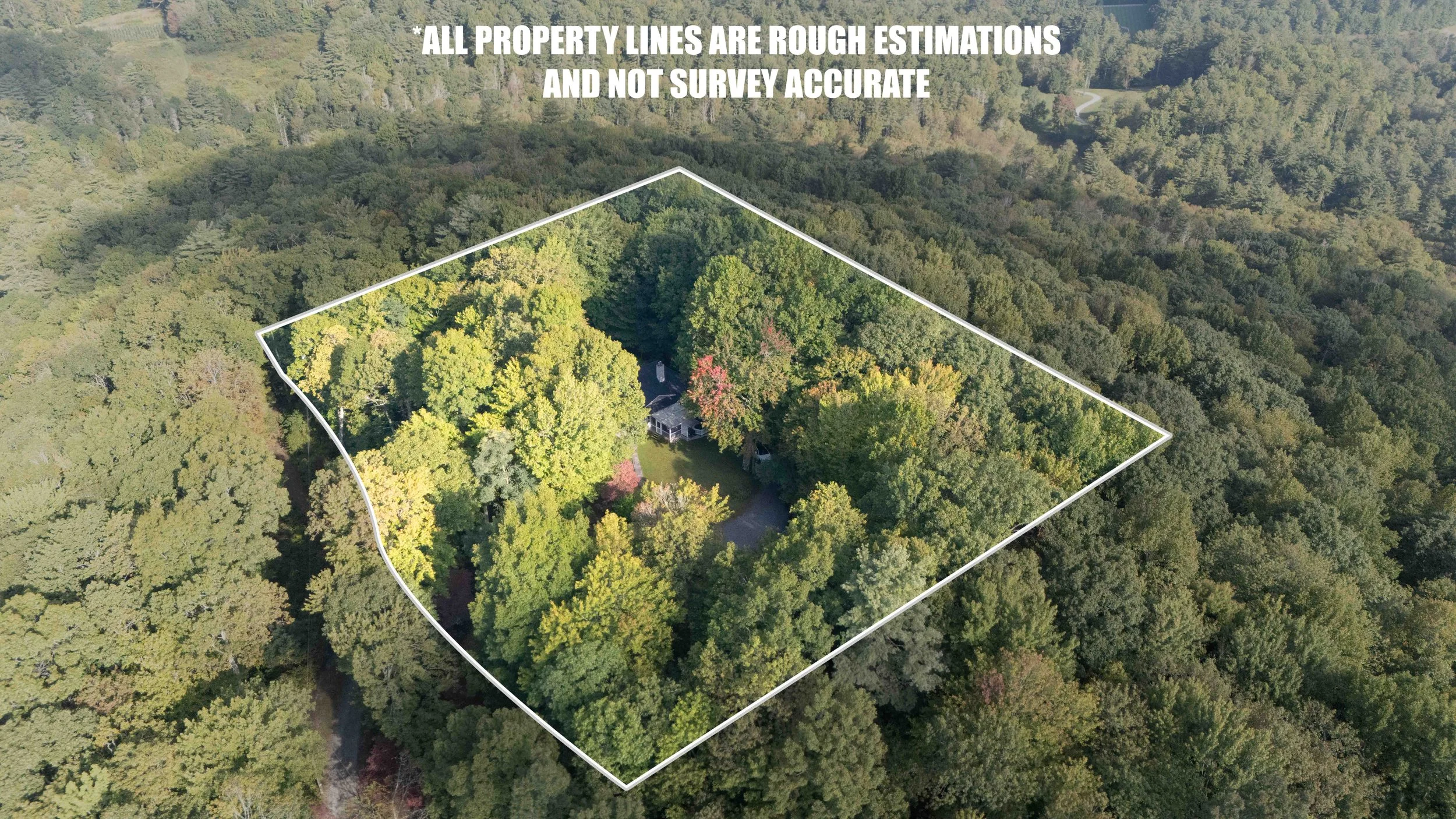 An aerial view of a wooded property with a house visible in the center, surrounded by trees, with property lines marked and a note stating that the lines are rough estimates and not survey accurate.