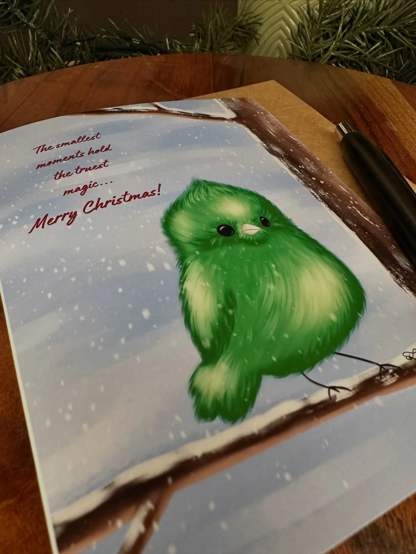 New Christmas card!! The sweetest little chubby green bird sitting on a snowy branch with the saying &ldquo;The smallest moments hold the truest magic. Merry Christmas!&rdquo; #christmascards #rochesterny #shoplocalroc 🎄💚