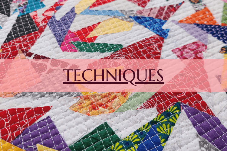 Colorful fabric-covered box with the word 'TECHNIQUES' written on a pink transparent overlay
