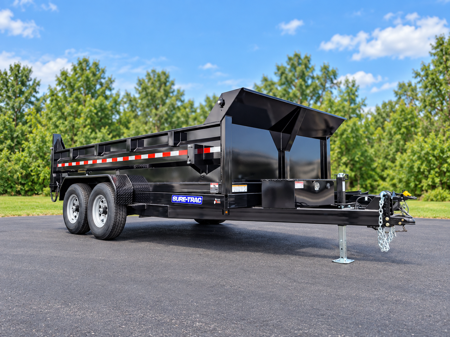 Black tandem-axle dump trailer on clean pavement
