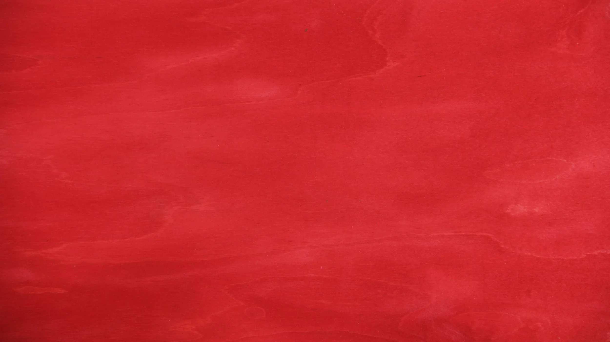 Ein roter, unscharfer Hintergrund ohne erkennbare Objekte.