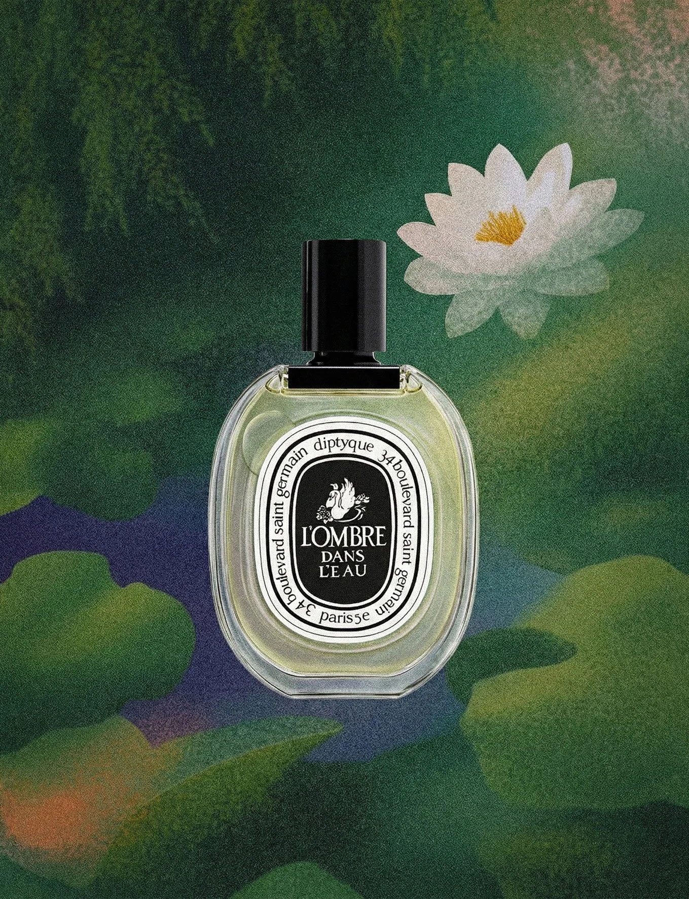 A perfume bottle labeled 'LOMBRE DANS L'EAU' sitting on a backdrop of a lotus flower and water lily leaves.