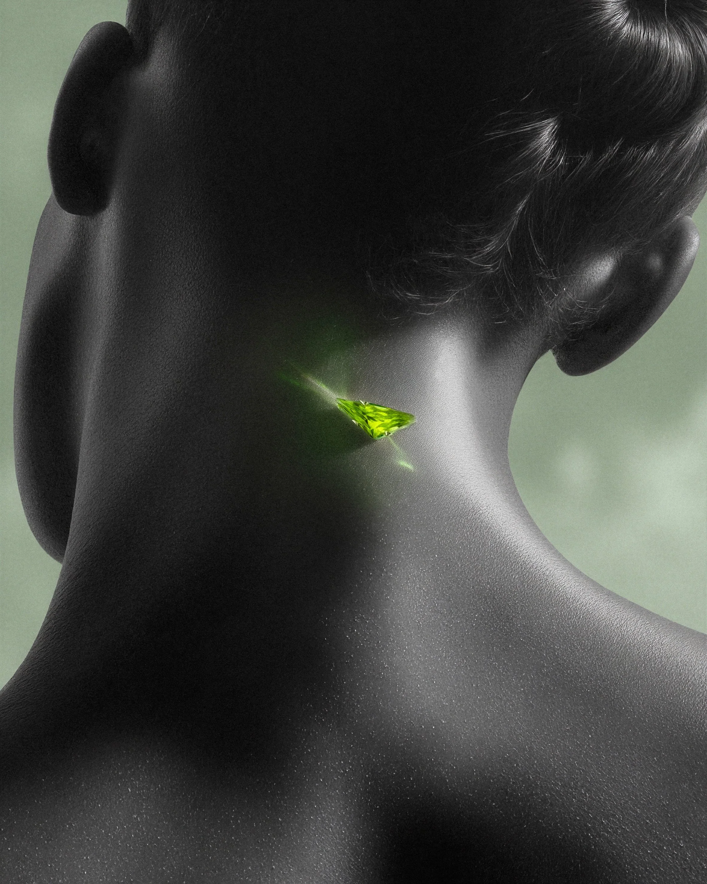 A close-up of a woman's neck with a glowing green gemstone embedded in the skin, against a muted green background.