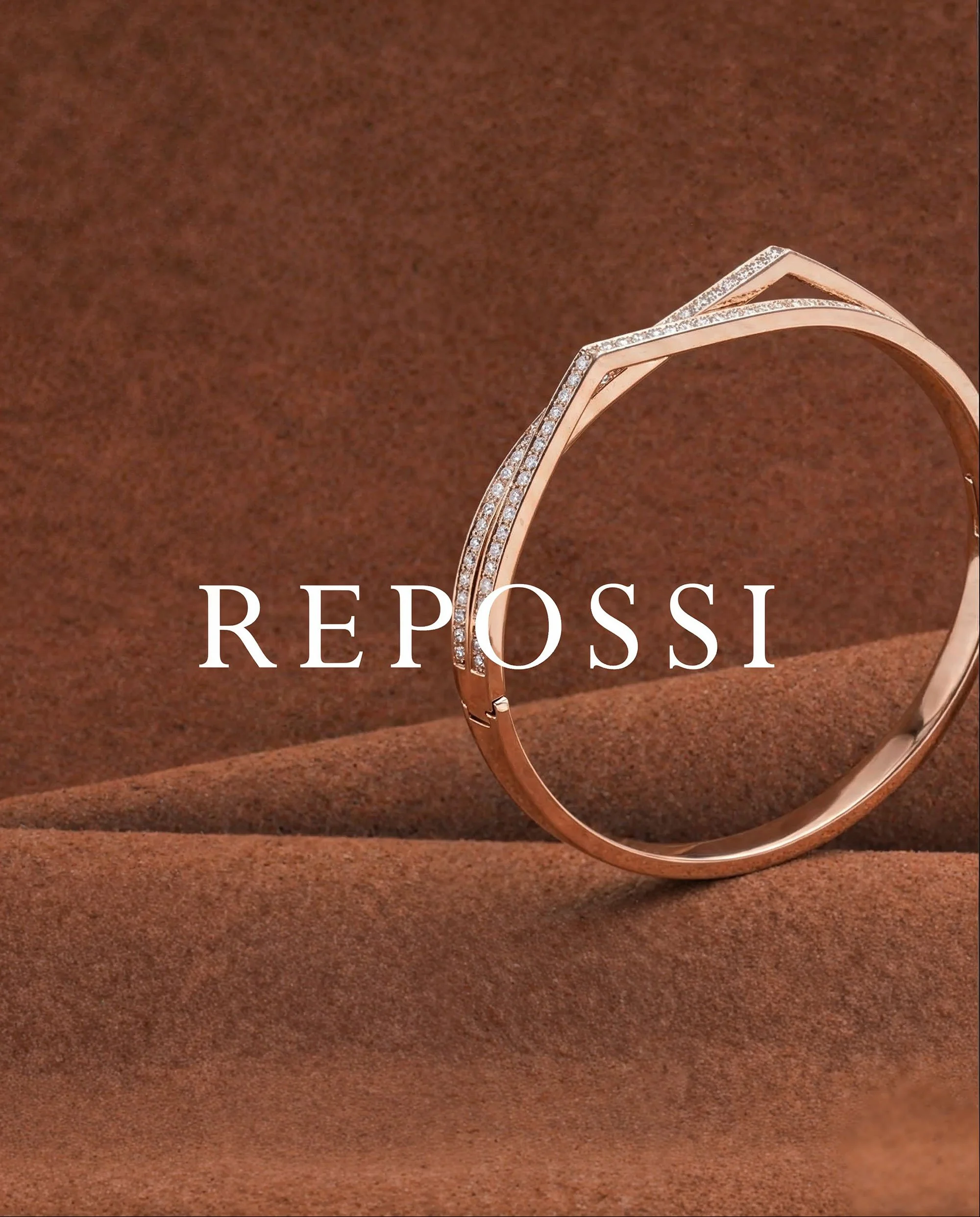 Gold bracelet with embedded diamonds displayed on a brown textured background with the word 'REPOSSI' superimposed in white text.
