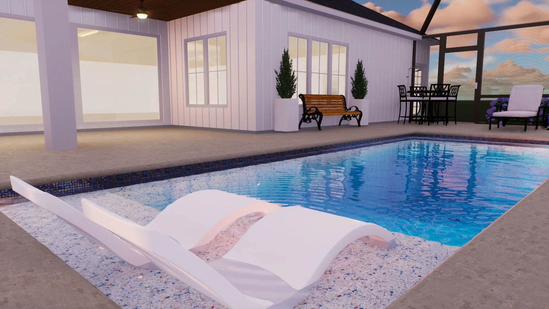 Empty indoor pool area with two white lounge chairs in the foreground, a wooden bench with black metal arms and two tall planters with greenery, and an outdoor seating area with a table and four chairs under a covered patio, with a glass enclosure an