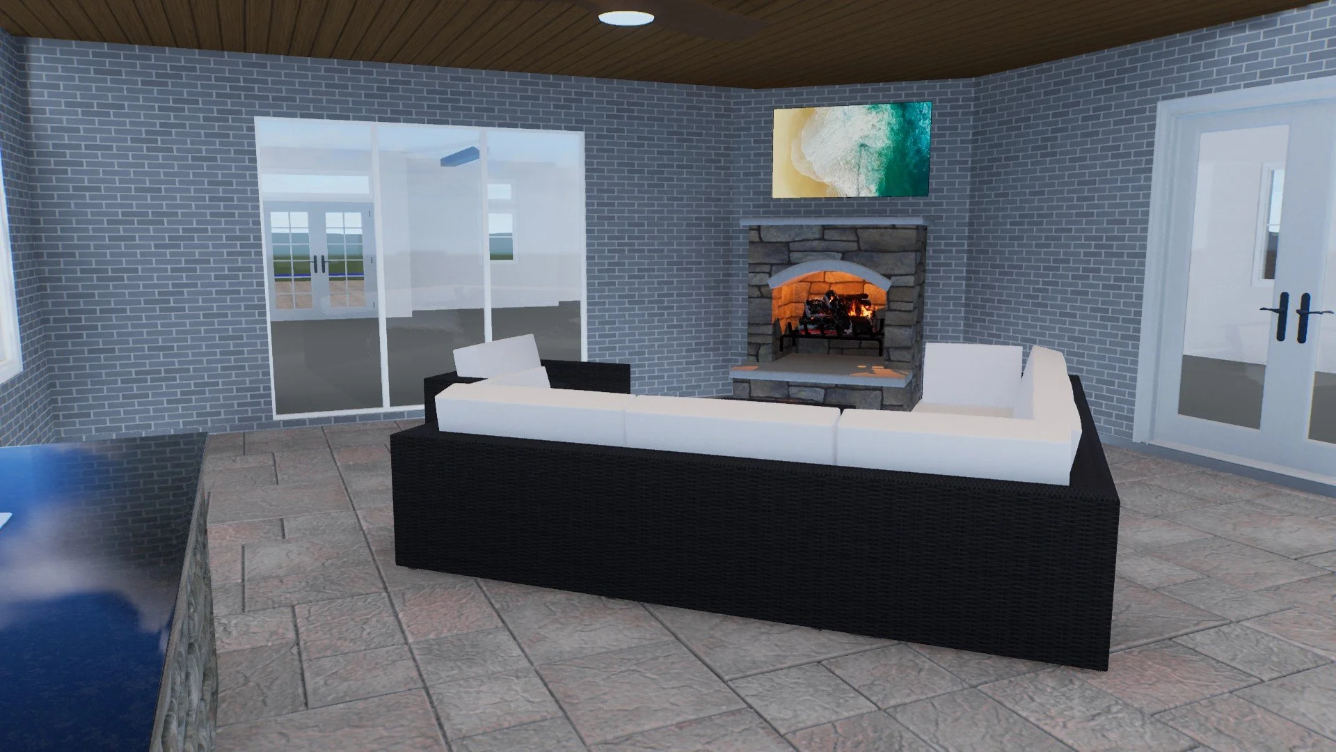 Living room with brick walls, fireplace, white and black sectional sofa, sliding glass doors, and a flat-screen TV above the fireplace.