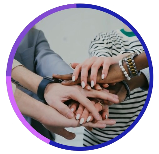 Multiple people stacking their hands together in a show of teamwork or unity.