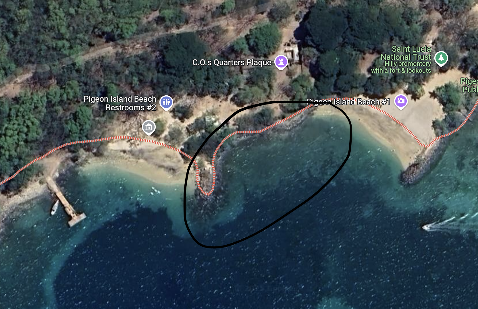 Snorkeling by the rocks at Pigeon Island National Park beach