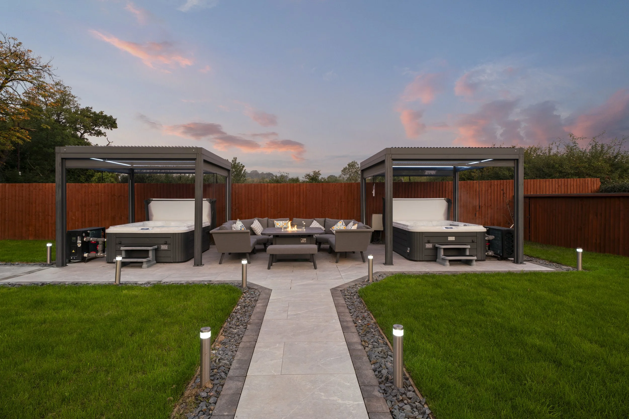 Two hot tubs and outdoor seating at Blacksmith Cottage