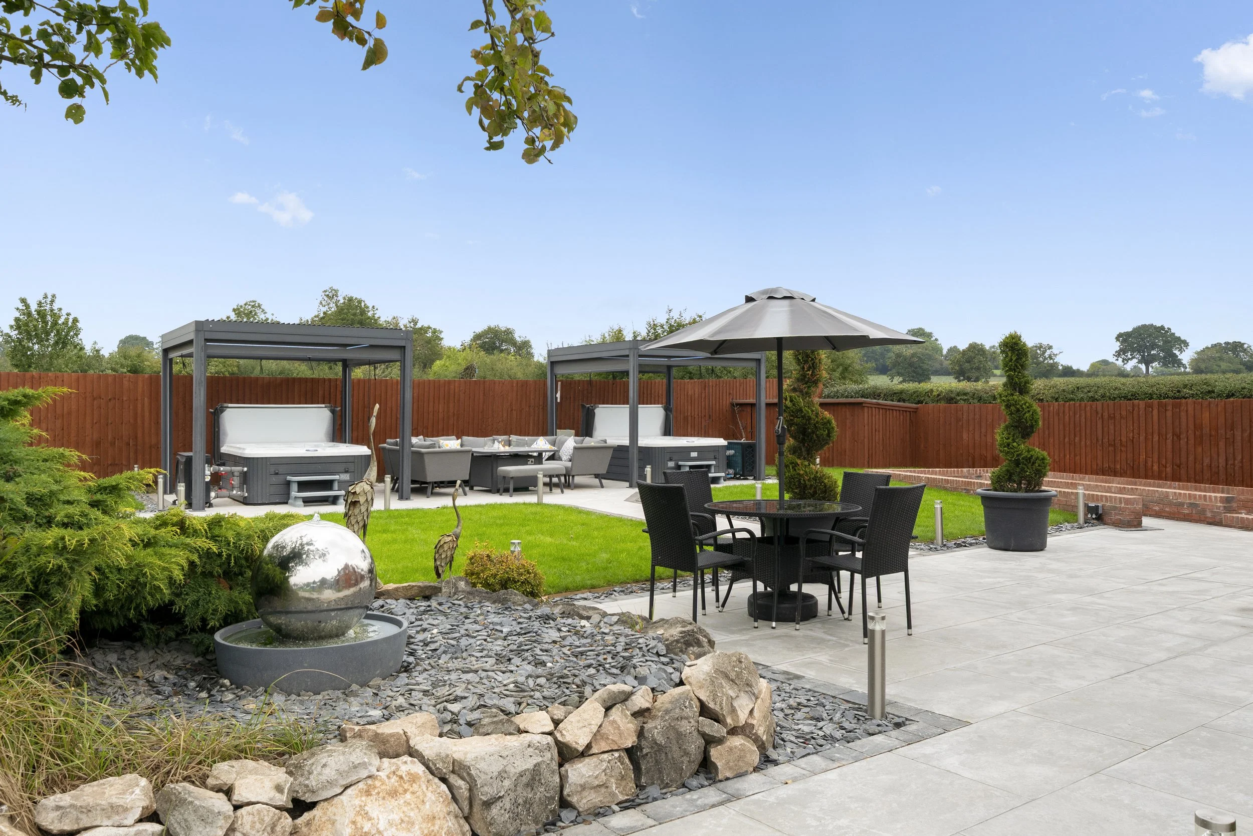 Two hot tubs and outdoor seating at Blacksmith Cottage