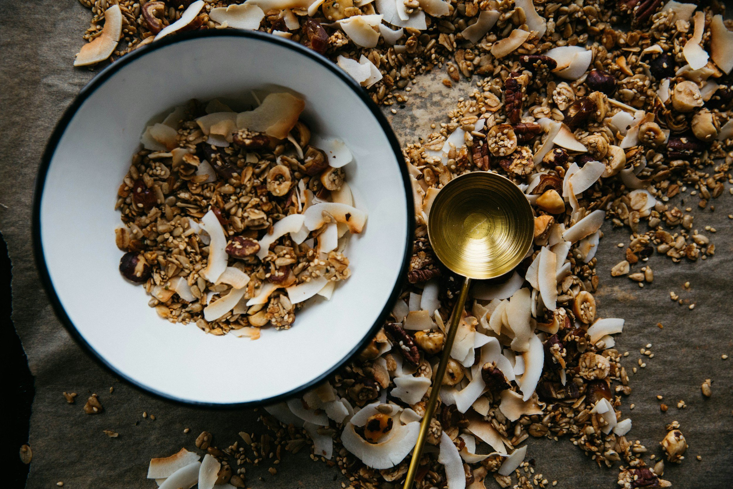 Preheat oven to 300F; Combine 4C organic oats, 1/2C pecan pieces, 1/2C raw sunflower seeds, and 1/2C coconut. (All add-ins are completely interchangeable for your favorite alternative). In a saucepan, melt 1C coconut oil with 1/2-3/4C honey; take off