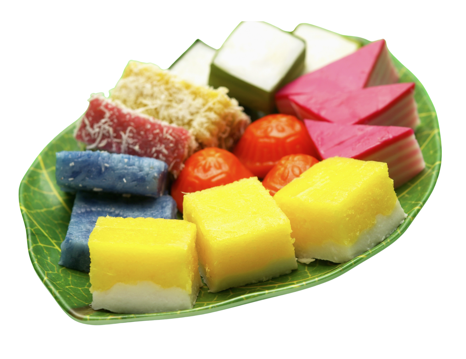 Assorted colorful layered desserts on a green leaf-patterned plate.