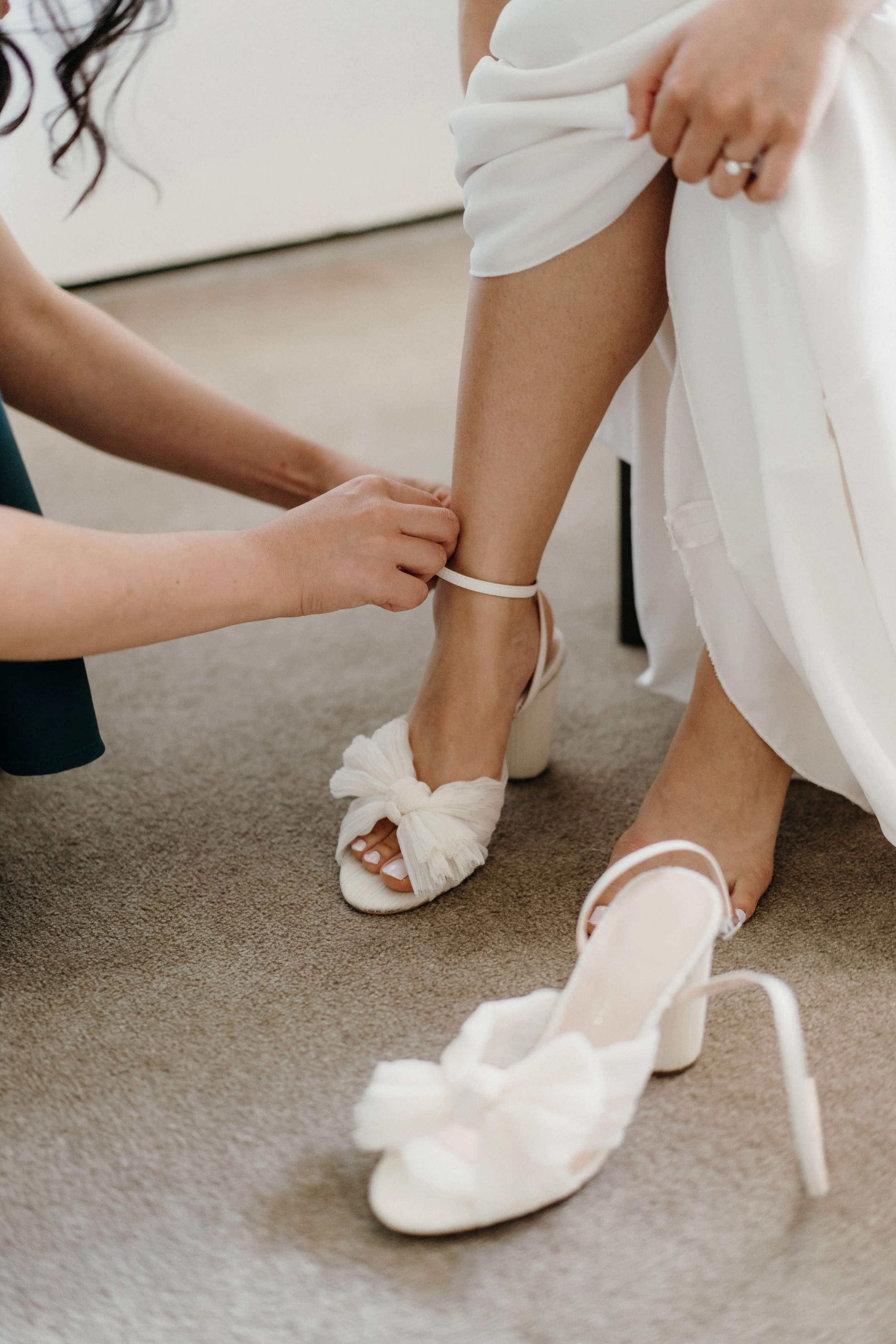 vertical-shot-of-a-girl-helping-the-bride-to-wear-2023-11-27-04-51-12-utc.jpg