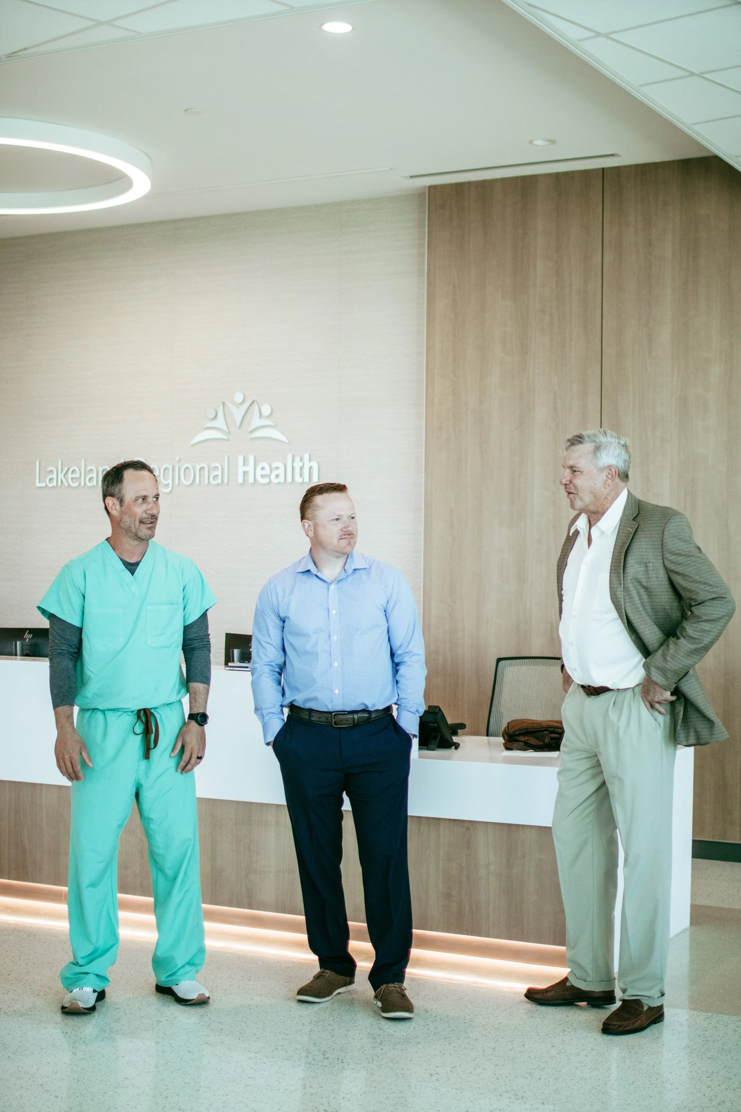  Right to left: Dr. Fred Blind, APNR James Wright and Dr. Jim Melton converse in the front lobby of the new ER 