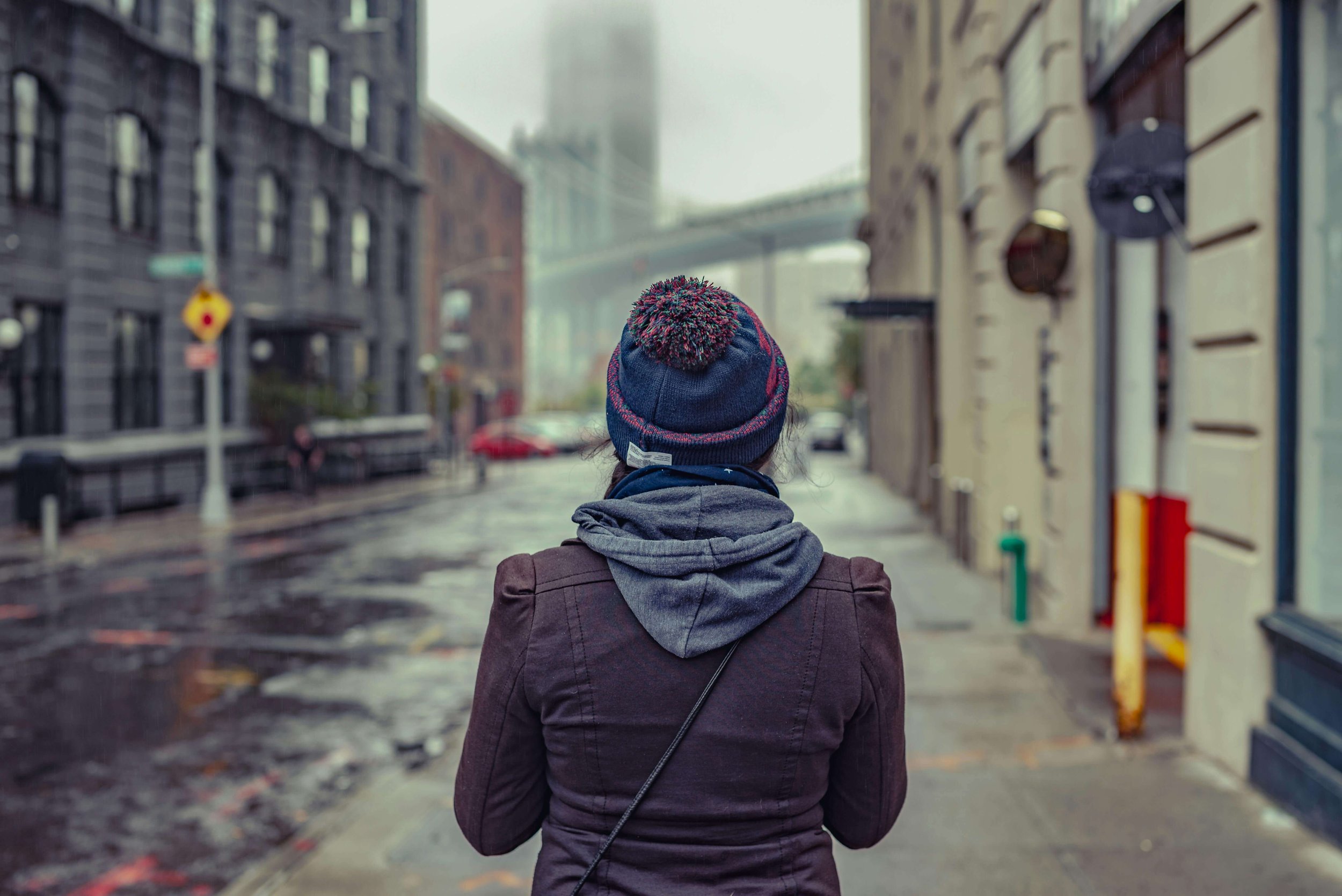 Young adult standing with their back to the camera in Manhattan, illustrating the pressure and transition of senior year explored in therapy for academic anxiety in Manhattan.
